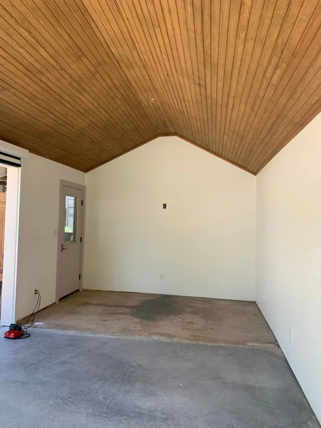 Warm honey-stained tongue and groove wood ceiling