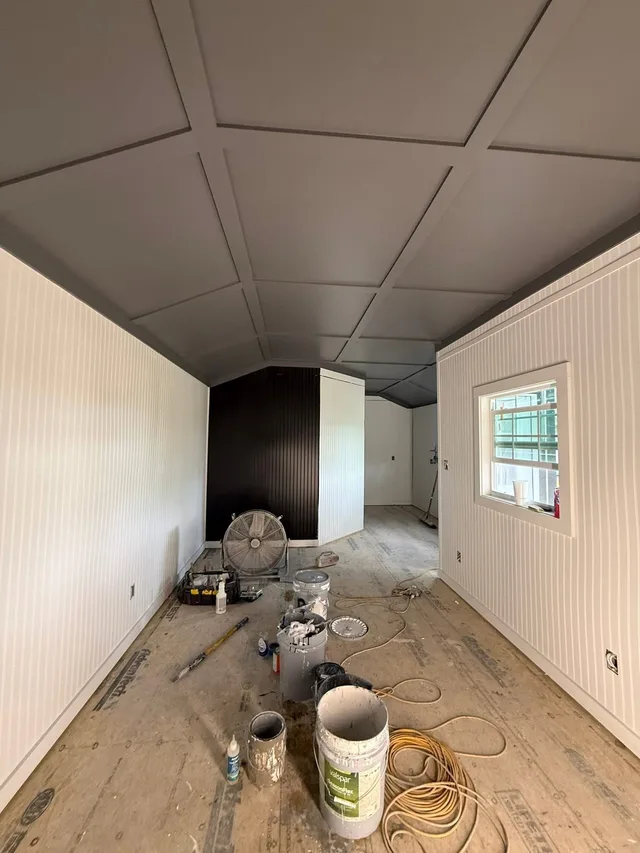 Room with finished dark painted ceiling
